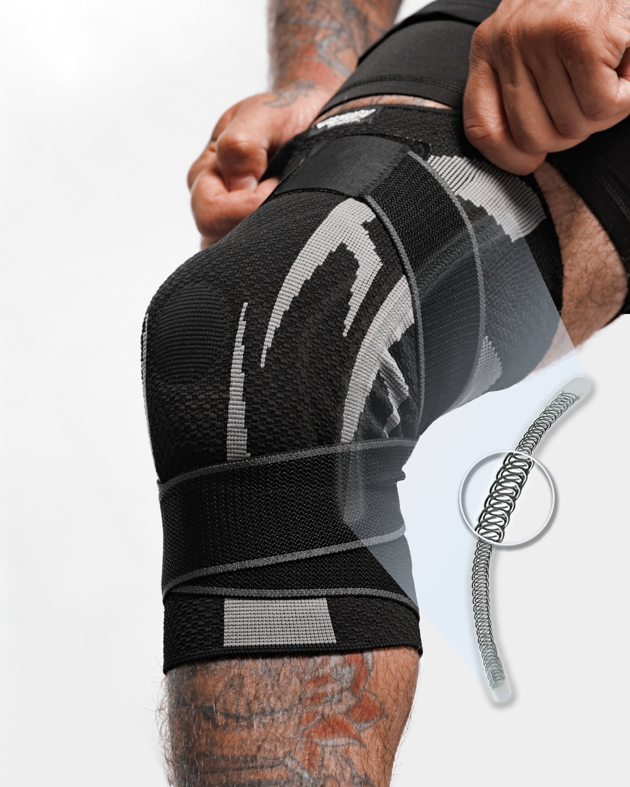 Man in rash guard and knee brace kneeling and looking at the camera.